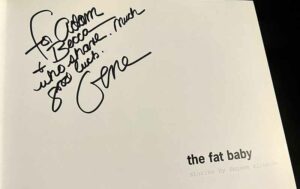 Signature page of a copy of Eugene Richards' book, the fat baby, with an autograph that reads, "for Adam & Becca who share. Much good luck. -Gene"