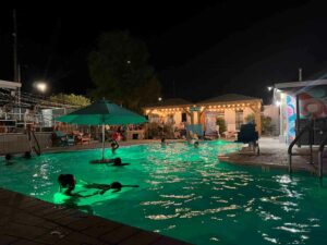 Swimming pool at night while the band plays at Hotel McCoy in Tucson