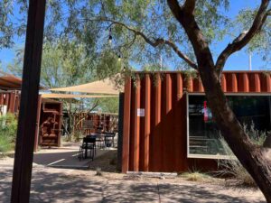 A maroon shipping container store at MSA Annex in Tucson