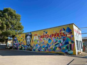 A brightly colored mural of Frida Kahlo by Gabriel Portillo and montywelt in Marfa, TX