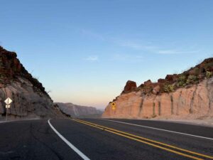 Early morning warm light of sunrise along Sunset popping up over the mountains along FM 170 in far west Texas