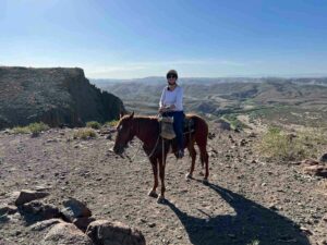 A white woman in her 40s on a horse in Big Bend Ranch State Park